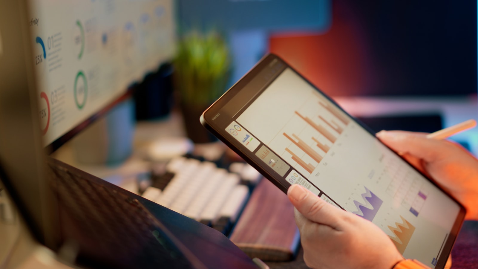 Professional reviewing analytical indicators on a digital tablet